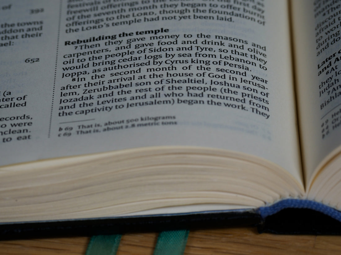 an open book sitting on top of a wooden table