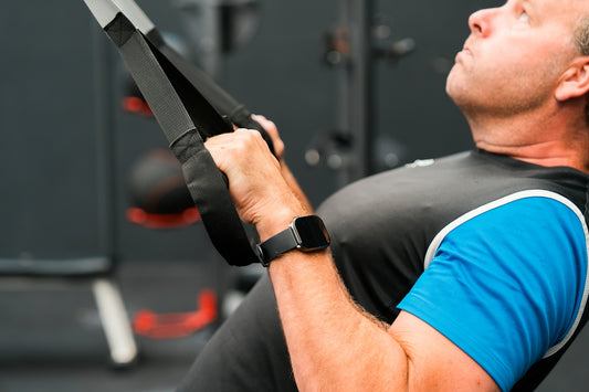 A man holding a pair of scissors in a gym